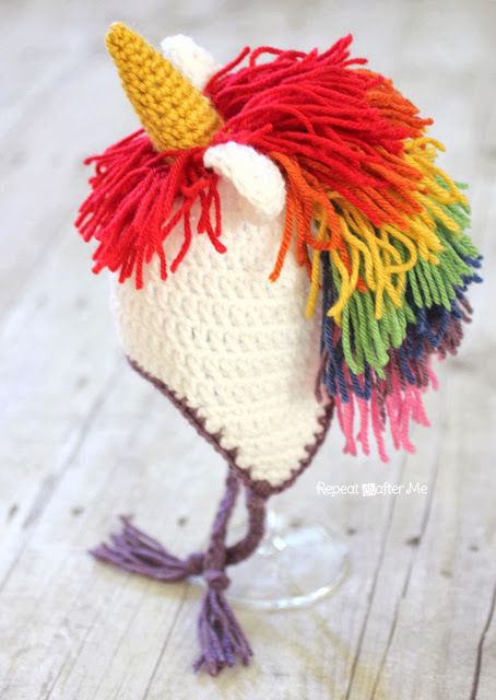 three different crocheted hats with unicorns on them and one has a rainbow mane