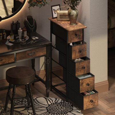 a desk with drawers and a clock on the wall above it, next to a stool