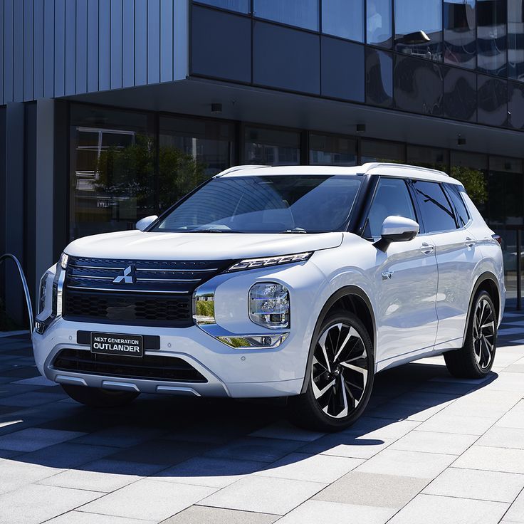 a white suv parked in front of a building