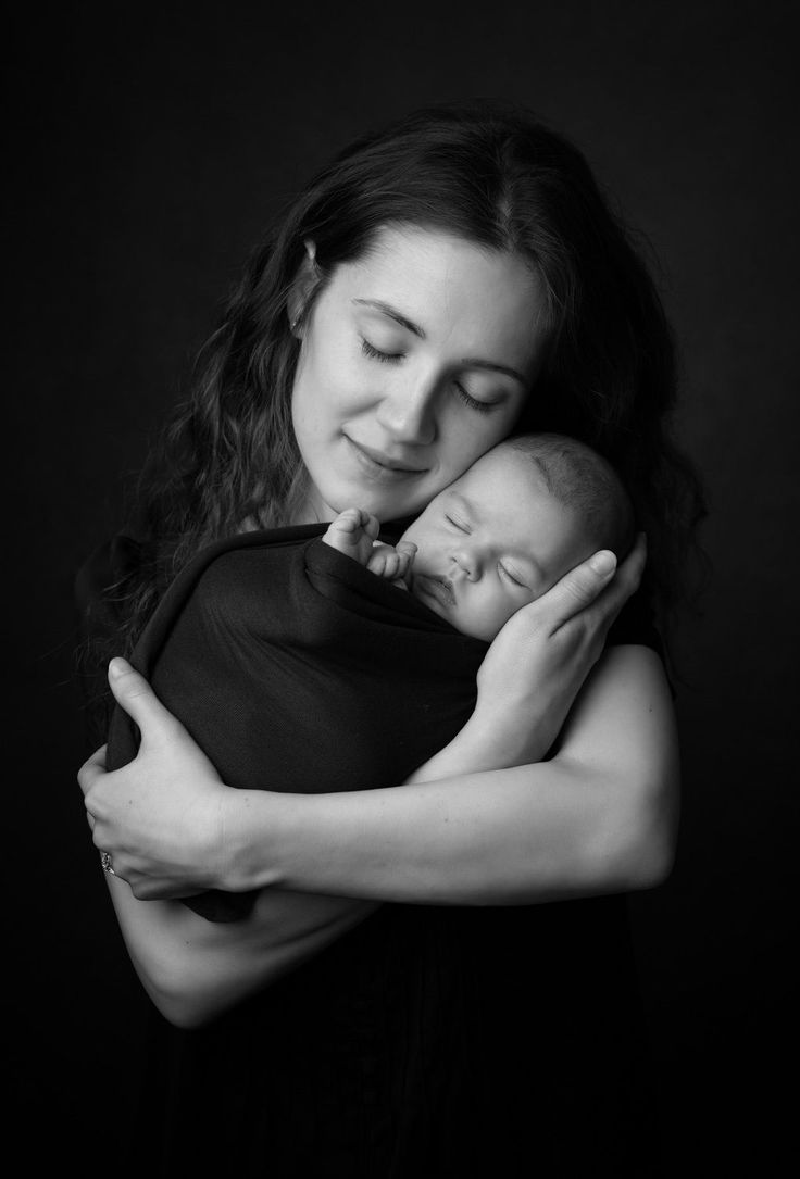 a woman holding a baby in her arms