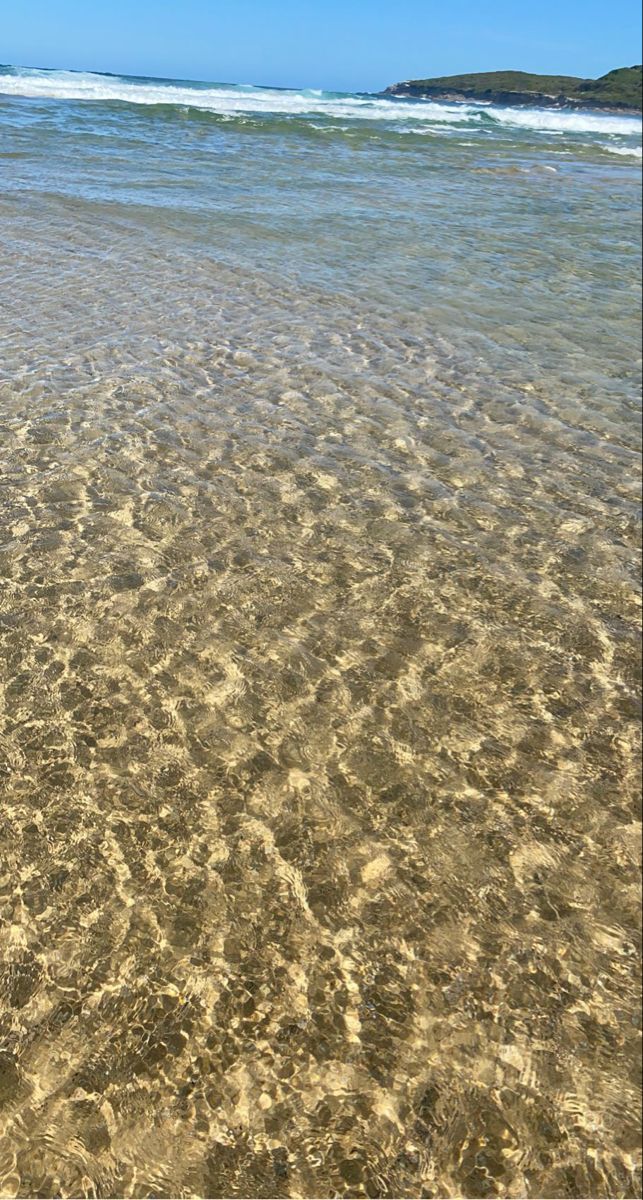 the water is so clear that you can see it's reflections in the sand