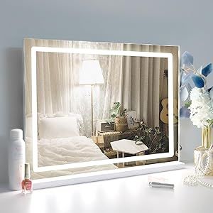 a white table with a mirror and flowers on it