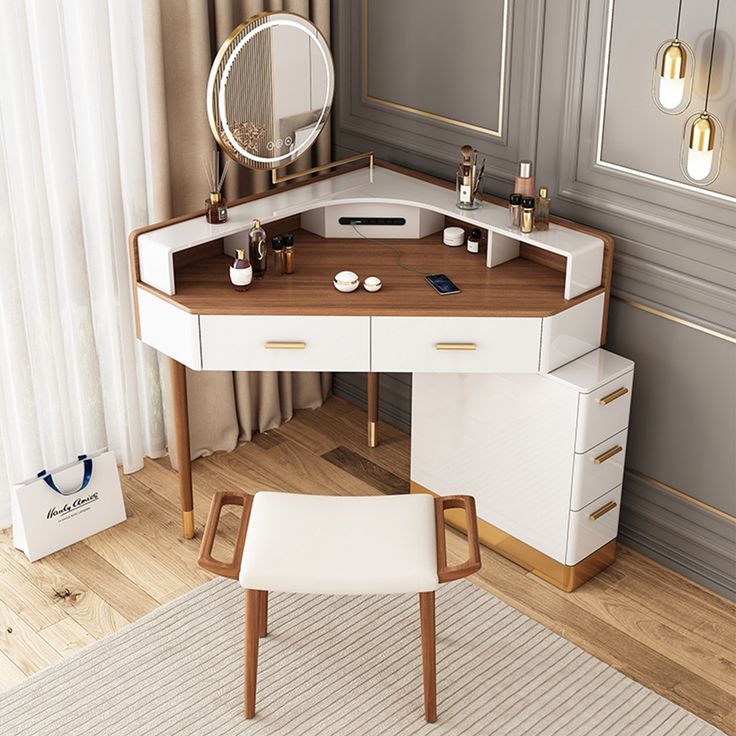 a desk with a mirror, stool and other items