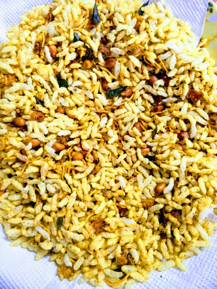 a white plate topped with yellow rice and nuts