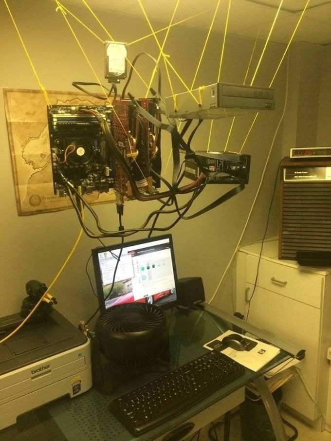 a laptop computer sitting on top of a desk next to a printer and other electronic equipment