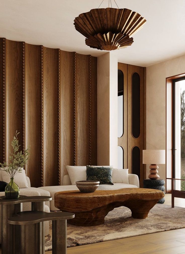 a living room filled with furniture and a wooden ceiling light hanging over the top of it