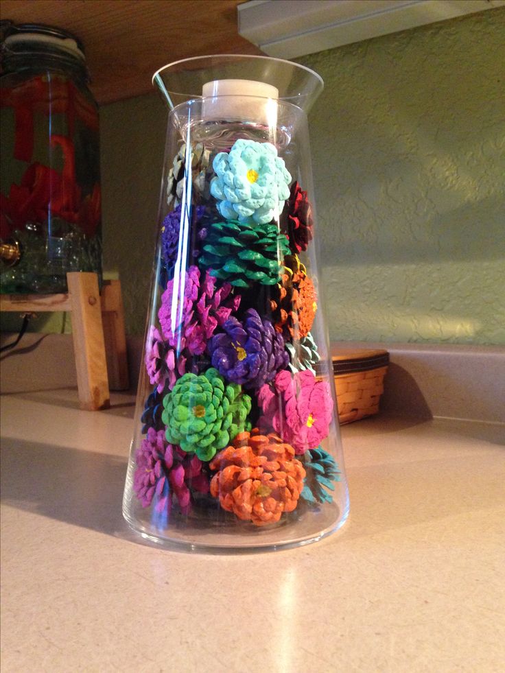 a vase filled with colorful flowers on top of a counter