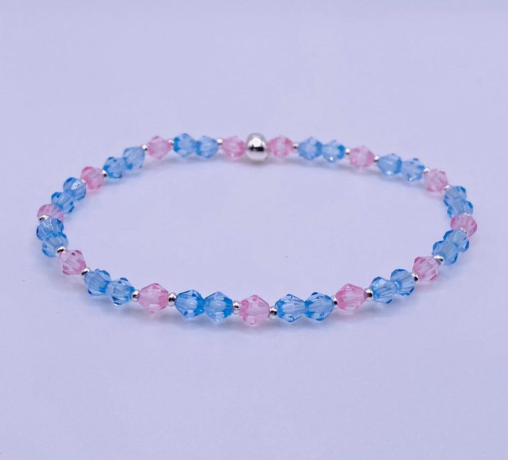 "Dainty blue and pink handmade bracelet perfect for the talk of the Ton. Part of \"The Ton\" collection. Stretch bracelet, sized to order." Pink And Blue Beaded Bracelets, Blue Jubilee Bracelet With Round Beads, Pink Jubilee Bracelet For Friendship, Blue Jubilee Stretch Bracelet, Blue Hypoallergenic Crystal Bracelet As Gift, Adjustable Blue Crystal Bracelet For Friendship, Blue Jubilee Stretch Bracelet As Gift, Blue Jubilee Bracelet As A Gift, Pink And Blue Bracelets