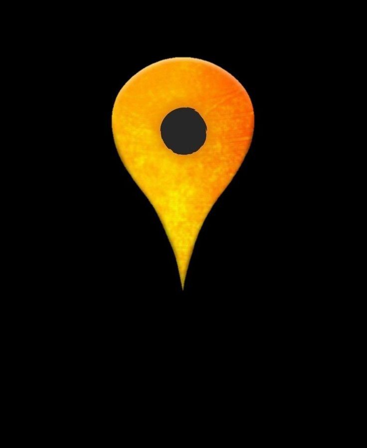 an orange marker with a black dot in the center on a black background photo by person