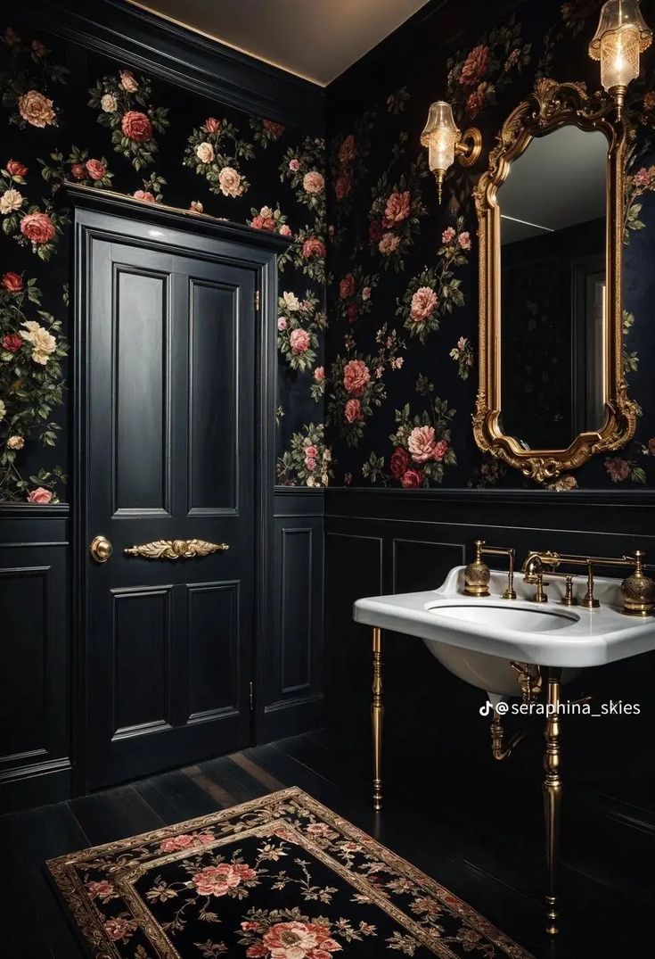 a bathroom with black walls, floral wallpaper and gold trim around the sink area