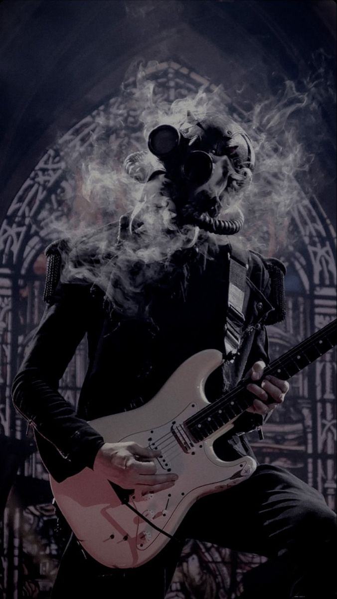 a man with a guitar in his hand and a skull mask on, playing the guitar