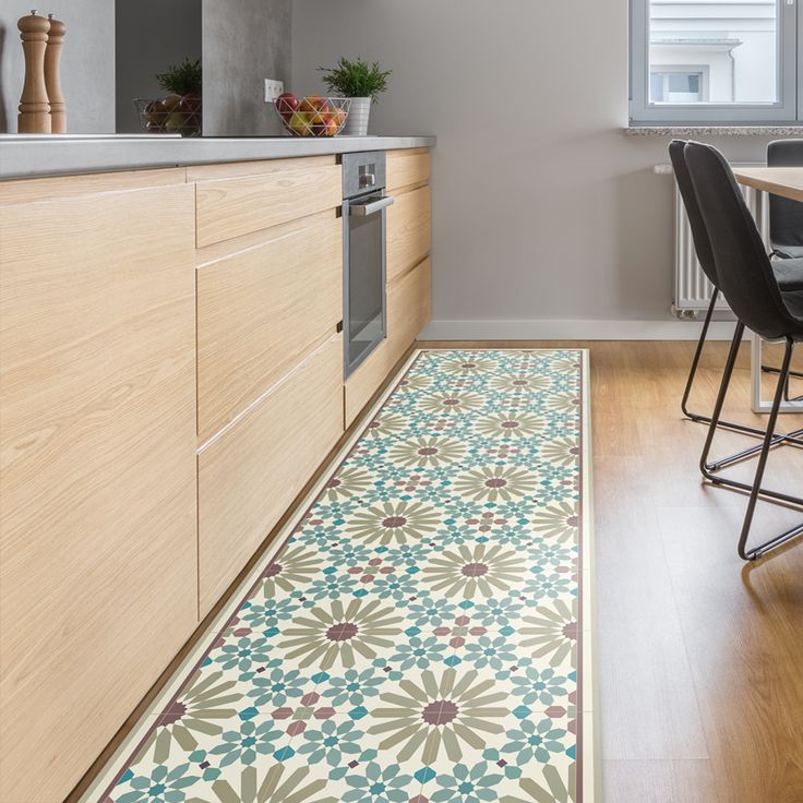 a kitchen with an area rug that looks like it has been painted in different colors