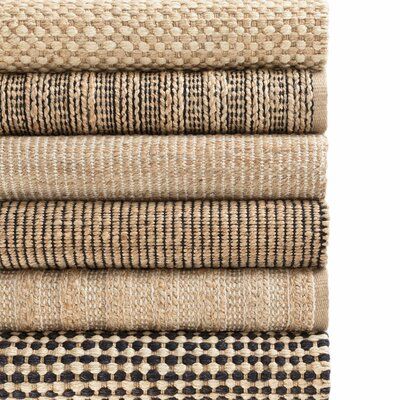 a stack of rugs with different patterns on them