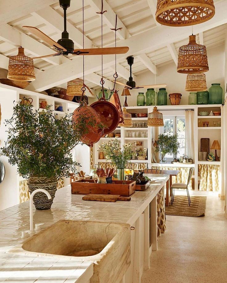 a kitchen filled with lots of pots and pans on top of a counter next to a sink