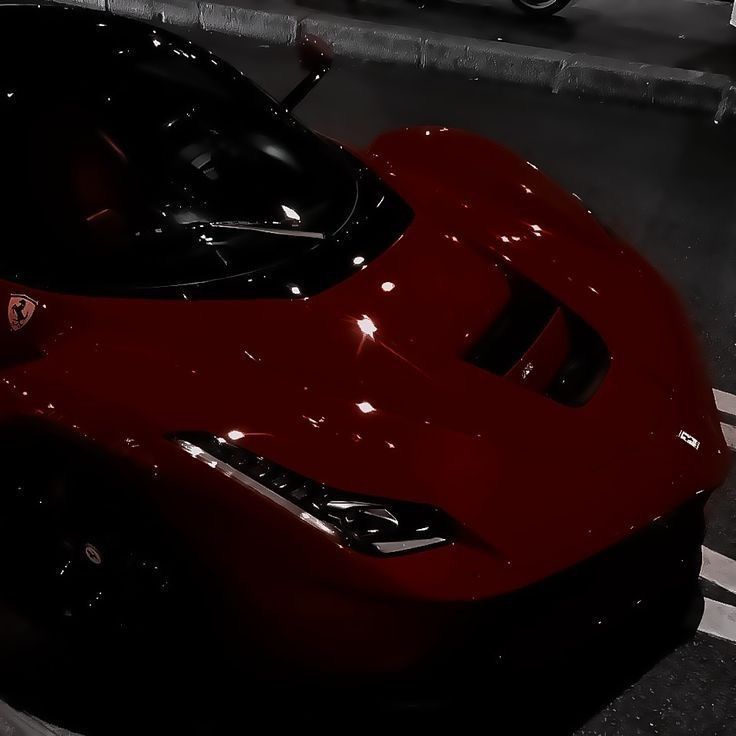 a red sports car is parked on the street