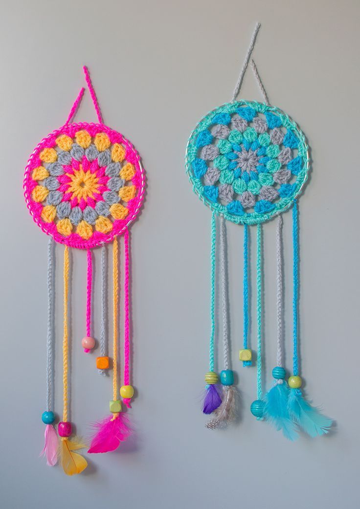 two crocheted dream catchers hanging from hooks