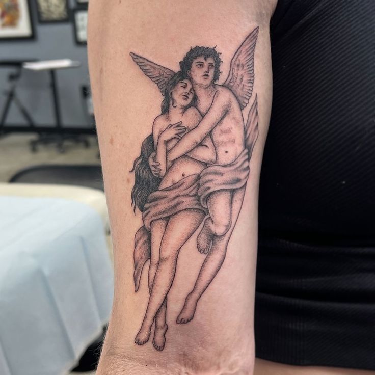 a woman with a tattoo on her arm holding a man