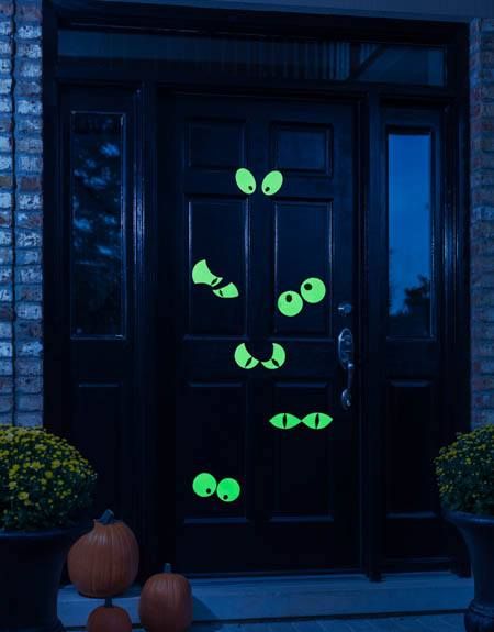 a black door with glow green fish on it and pumpkins in the foreground