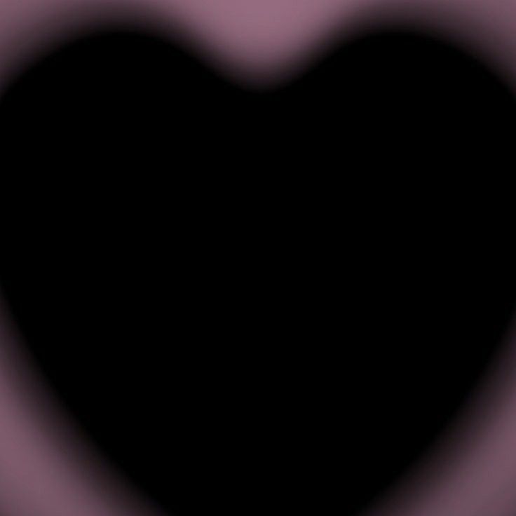 a black heart shaped object in the middle of a blurry image with pink and purple colors