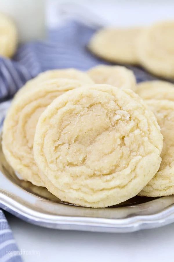 some cookies are sitting on a plate with blue and white striped napkins behind them