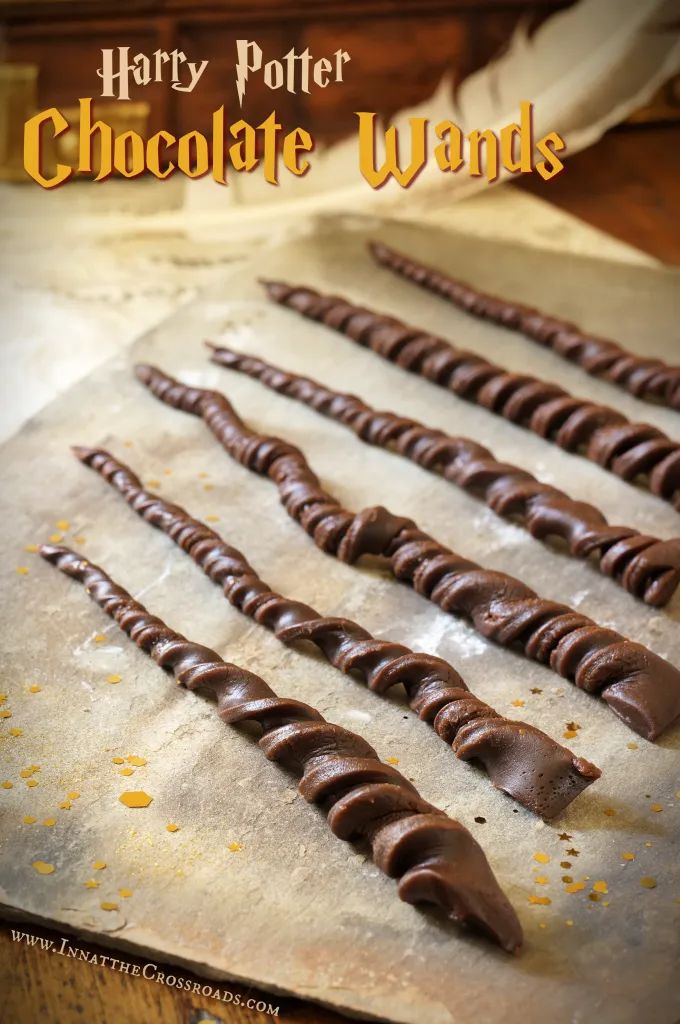 chocolate wands are lined up on a baking sheet with the title harry potter chocolate wands