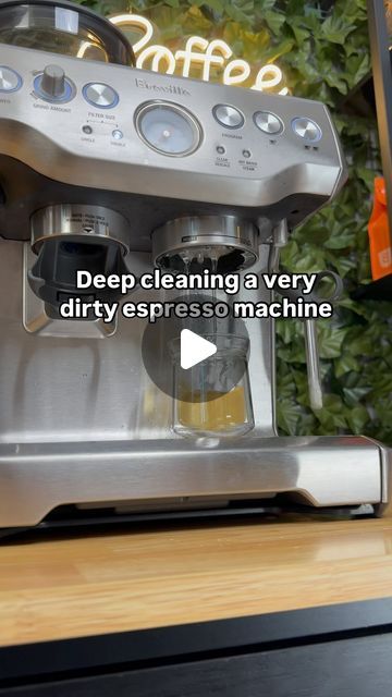 a coffee maker sitting on top of a counter next to a sign that reads deep cleaning a very dirty espresso machine