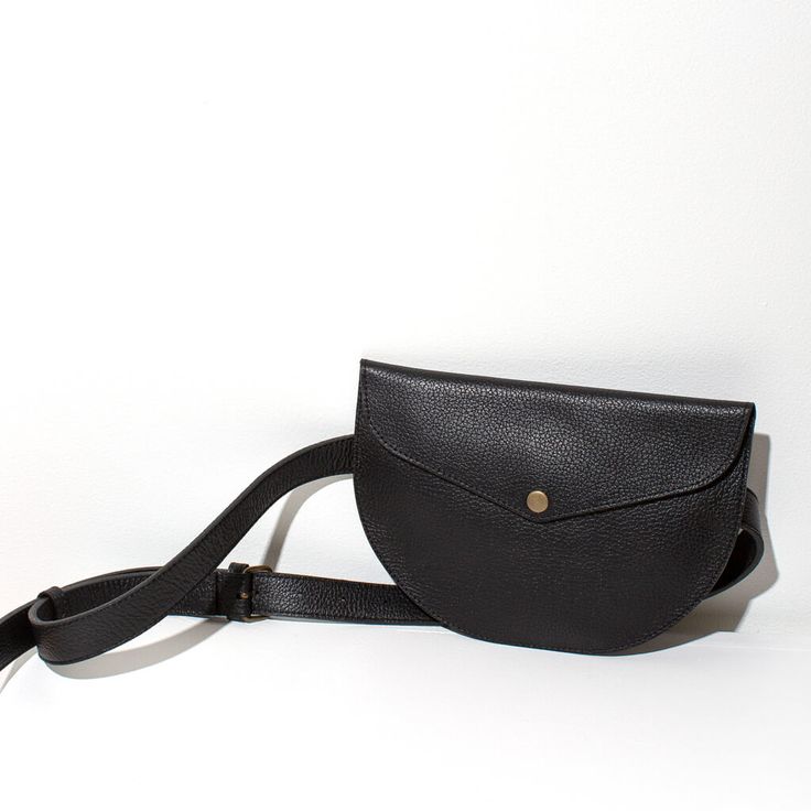 Add a stylish, functional touch to any outfit with our leather crossbody belt bag. Handmade by skilled artisans, this on-trend crossbody bag features an adjustable belt for a perfect fit. Perfect for travel or around-town. Wear around your waist, over the shoulder or cross-body. Soft yet structural leather. While our designs are modern, our approach is based in capturing the ancient. We collaborate with master craftspeople to create each piece. Size: 6 inches tall x 9 inches wide, flat profile B On-the-go Crossbody Shoulder Bag With Removable Belt, Crossbody Shoulder Bag With Removable Belt, Crossbody Shoulder Bag With Removable Belt For On-the-go, Removable Belt Crossbody Shoulder Bag For On-the-go, Everyday Crossbody Shoulder Bag With Removable Belt, Leather Crossbody Belt Bag For Everyday, Classic Black Belt Bag With Detachable Strap, Chic Everyday Belt Bag With Adjustable Strap, Travel Shoulder Bag With Removable Belt