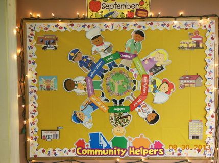 a bulletin board is decorated with children's community helpers stickers and lights