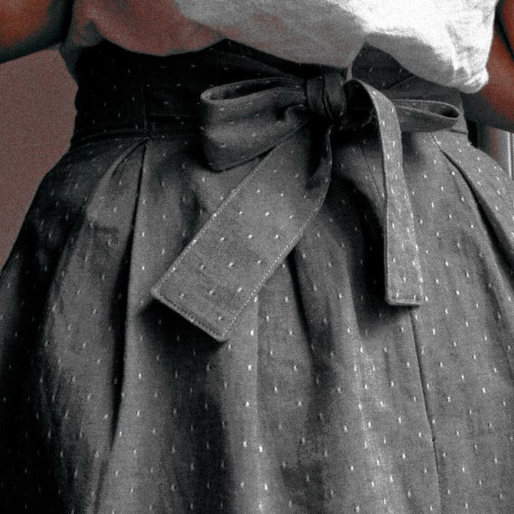 black and white photograph of woman's skirt with polka dots