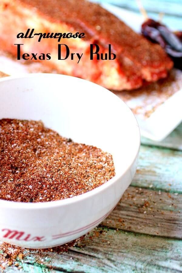 a white bowl filled with dry rubs next to meat on top of a wooden table