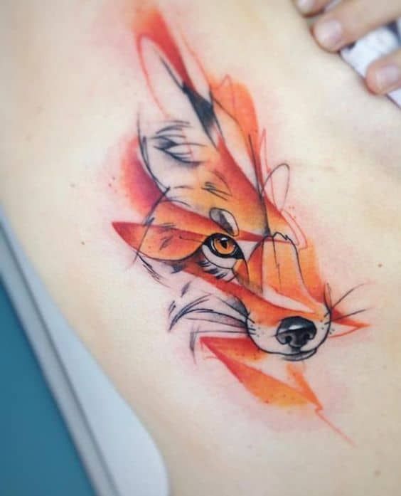 a woman's stomach with a fox tattoo on it