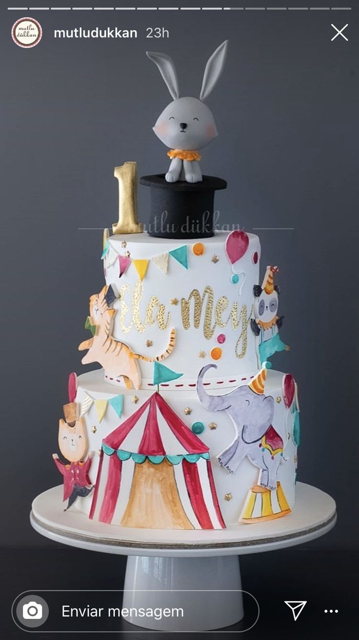 a three tiered cake with an animal topper