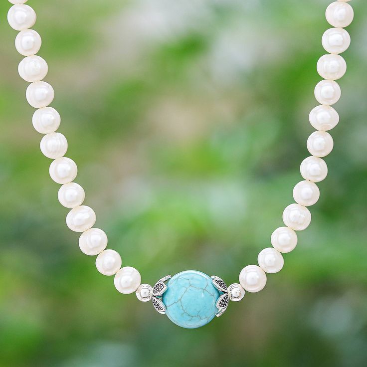 Prim and proper with a breezy pop of sky blue Tipa's pearl necklace offers effortless sophistication. The Thai artisan centers the strand of cultured freshwater pearls with a globe of reconstituted turquoise while sterling silver accents add a touch of glamour. Turquoise Jewelry With Pearl Chain And Round Beads, Elegant Turquoise Necklace With Round Beads, Turquoise Pearl Necklace With Pearl Drop, Turquoise Pearl Jewelry With Pearl Charm, Elegant Turquoise Pearl Jewelry With Pearl Charm, Elegant Turquoise Necklace With Natural Stones, Turquoise Pearl Necklace With Round Beads, Turquoise Pearl Necklace Gift, Turquoise Pearl Necklace With Natural Stones