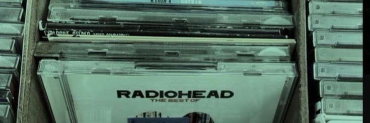 the radiohead records are stacked on top of each other