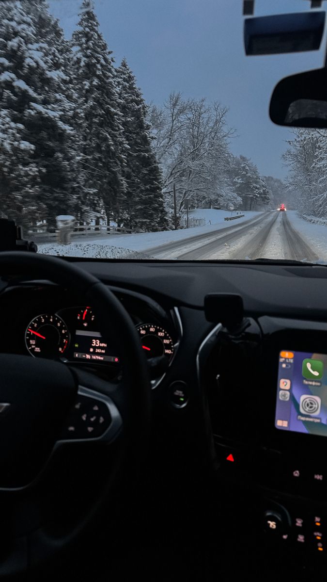 the dashboard of a car on a snowy road