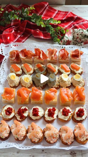 a table topped with lots of food on top of a white tray covered in sauce