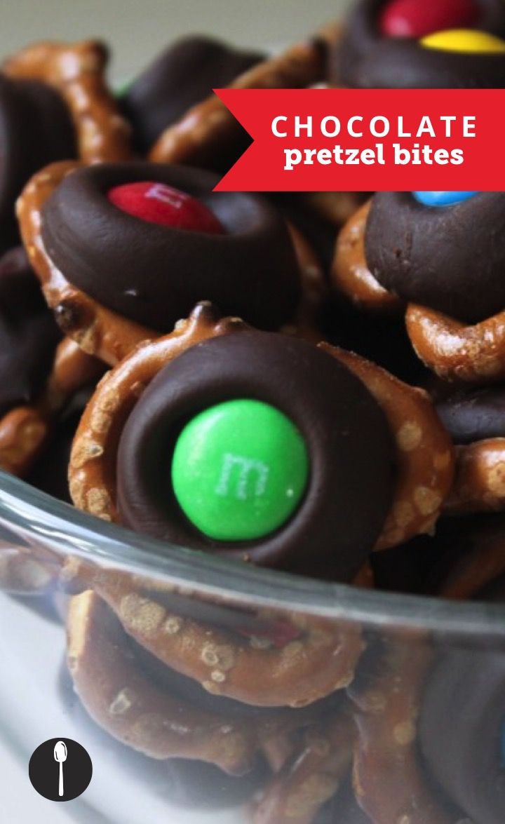 chocolate pretzel bites in a bowl with m and m candies on top