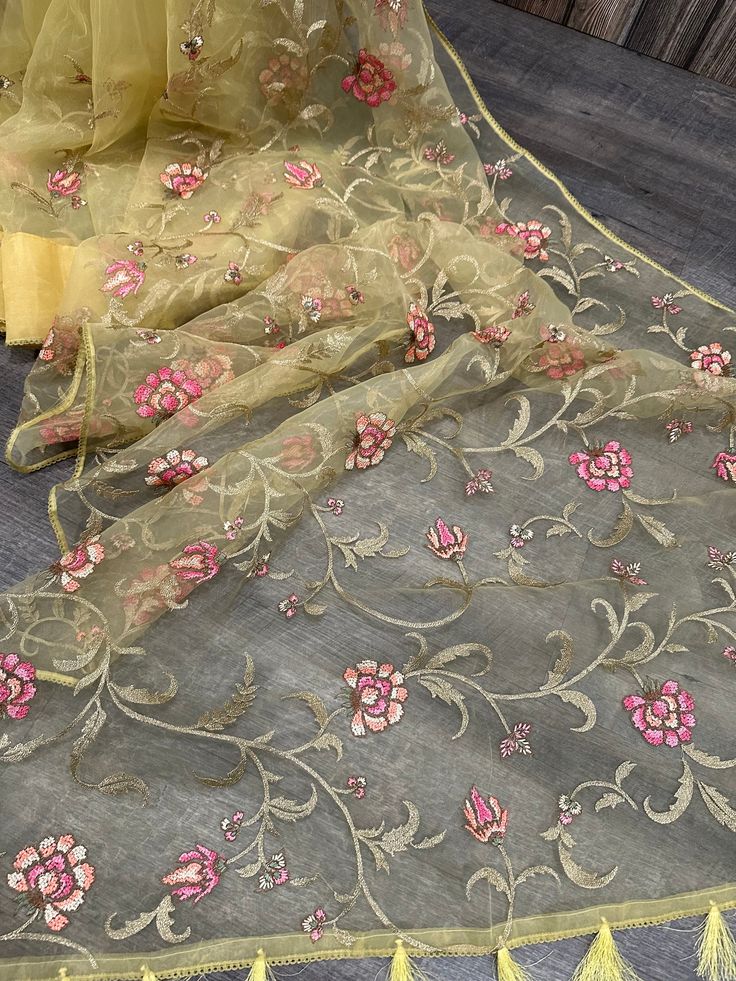 Lightweight and sheer Dhakai Muslin saree with floral resham and zari embroidery . Printed blouse fabric included. Pista Green Traditional Wear With Floral Embroidery, Diwali Floral Embroidered Silk Pre-draped Saree, Festive Pre-draped Saree With Floral Embroidery In Art Silk, Pista Green Chanderi Salwar Kameez With Floral Embroidery, Transitional Traditional Wear With Floral Embroidery In Pista Green, Anarkali Silk Saree With Floral Embroidery, Silk Anarkali Pre-draped Saree With Floral Embroidery, Anarkali Pre-draped Silk Saree With Floral Embroidery, Bollywood Organza Pre-draped Saree With Floral Embroidery