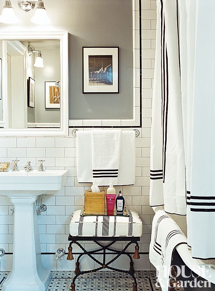 a white bathroom with black and white decor