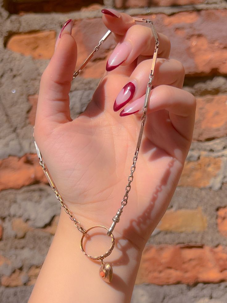 Perhaps one of the coolest rings we've found this year, herein find a gorgeous Edwardian celtic knot ring featuring a beautiful heart charm with a small coral cabochon. Traditionally a stone of feminine prowess, the coral cabochon is known as a symbol of fertility and passionate love- what could be more divine a gift for your beloved? Age/Origin: English, 1920 Materials: 9ct pink gold, Coral Weighs: 3.2 Size: 7.75 Marks: None Condition: Excellent for her age- so hard to find pieces like this the Timeless Silver Heart Pendant Jewelry, Polished Finish Oval Link Jewelry For Gifts, Oval Link Jewelry With Polished Finish For Gift, Elegant Brass Jewelry With Heart Charm, White Gold Jewelry Ring Detail For Gift, Tarnish Resistant Oval Metal Jewelry, Hallmarked White Gold Oval Link Jewelry, Dainty Metal Ring Jewelry For Formal Occasions, Timeless Heart Charm Jewelry For Formal Occasions