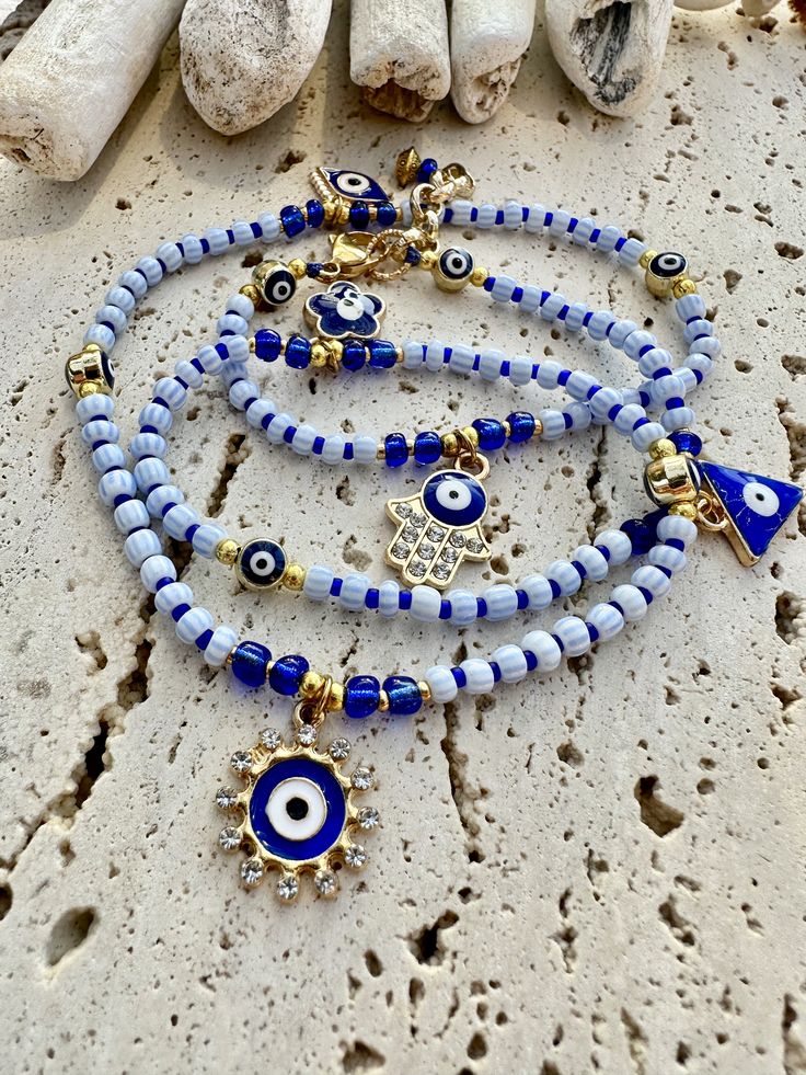 Vintage blue and white seed beads, small dark blue seed bead between large ones, all evil eye charms, wrap around 3 times with extra chain for all sizing. This can be worn as a necklace.  23 inches long Vintage Blue And White, Bracelets Design, Seed Bead Bracelet, Diy Bracelet Designs, Evil Eye Charm, Seed Bead Bracelets, Diy Bracelet, Bead Bracelet, Bracelet Designs