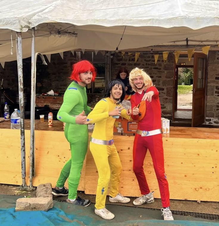 three people dressed in costumes standing next to each other