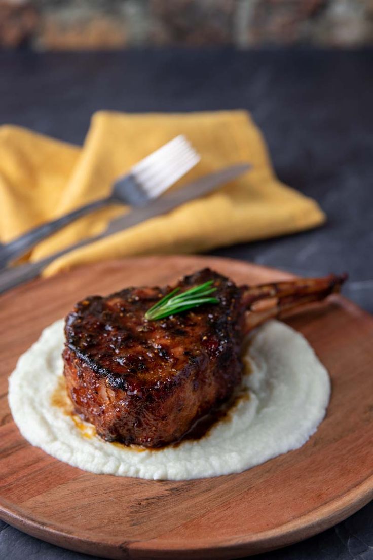 a piece of meat sitting on top of a wooden plate