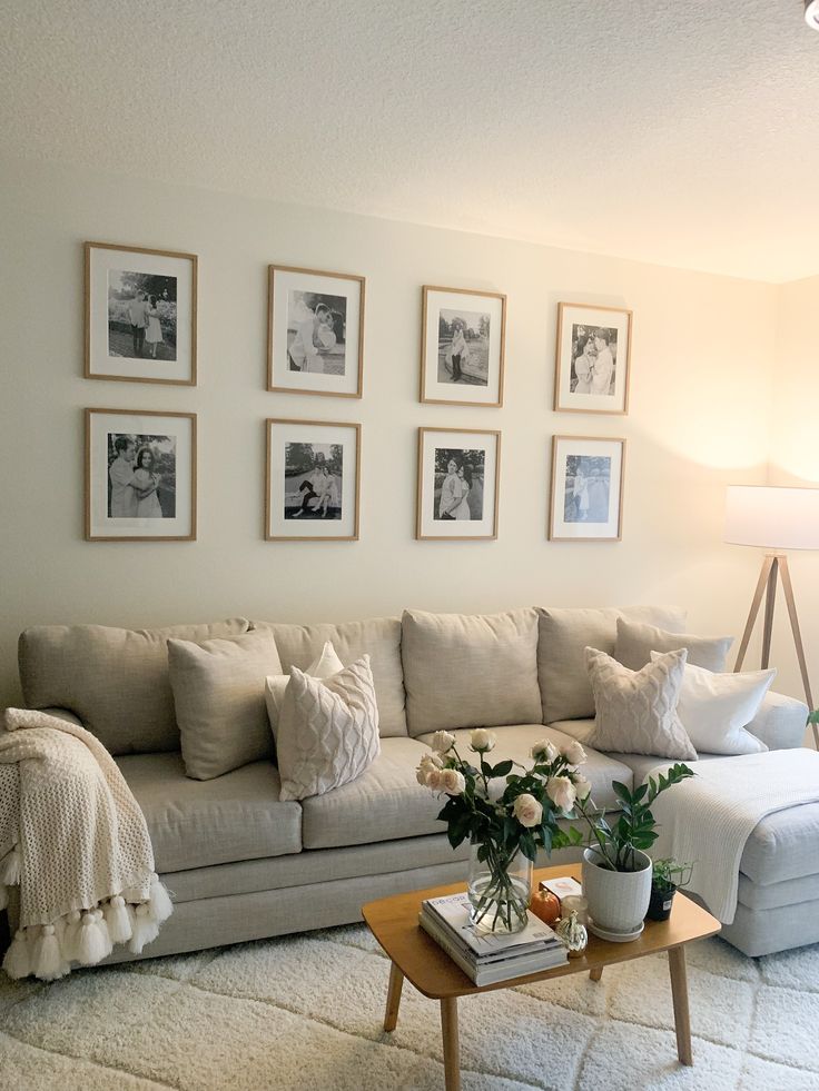 a living room filled with lots of furniture and pictures on the wall above it's coffee table