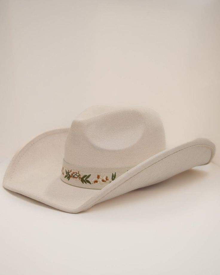 Add a touch of western glam to your outfit with our Cream Floral Embroidered Strap Cowboy Hat! This cute white cowboy hat features a strap embroidered with pretty flower details and pairs well with virtually anything. White Adjustable Felt Hat With Curved Brim, White Adjustable Curved Brim Felt Hat, White Brimmed Hat Bands For Rodeo, White Wide Brim Felt Hat For Rodeo, Western Style Felt Hat For Spring Events, White Western Felt Hat With Curved Brim, Western White Felt Hat With Curved Brim, Western Style Felt Hat For Ranch In Spring, White Western Hat For Spring