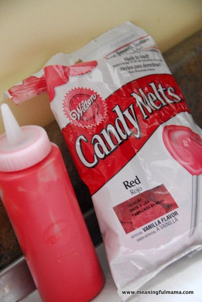 candy melts are sitting on the counter next to a pink cup and bottle with a straw in it