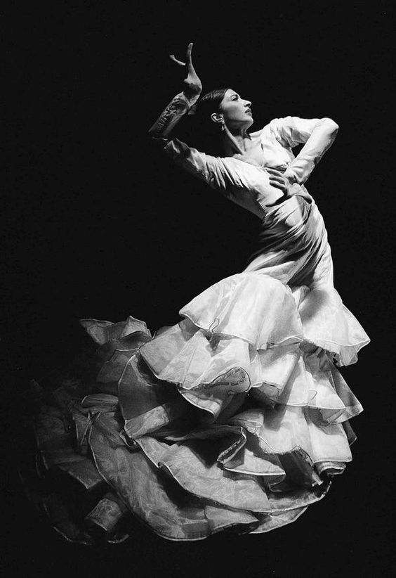 a black and white photo of a woman dancing