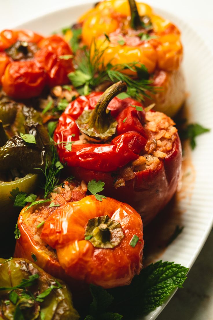 a white plate topped with stuffed bell peppers