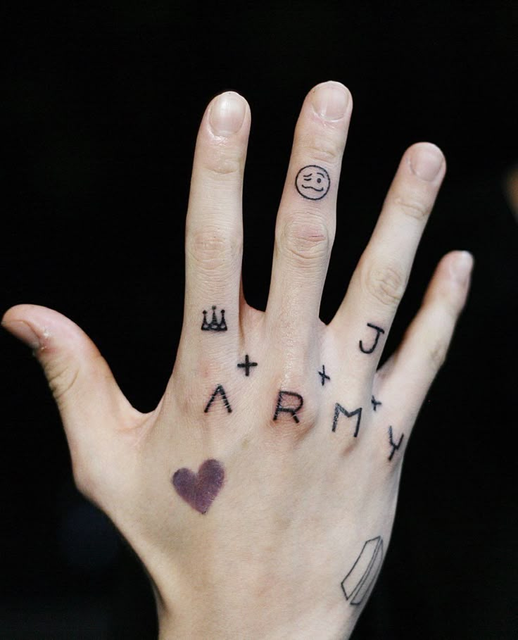 a person's hand with tattoos on it and the word army painted on their palm