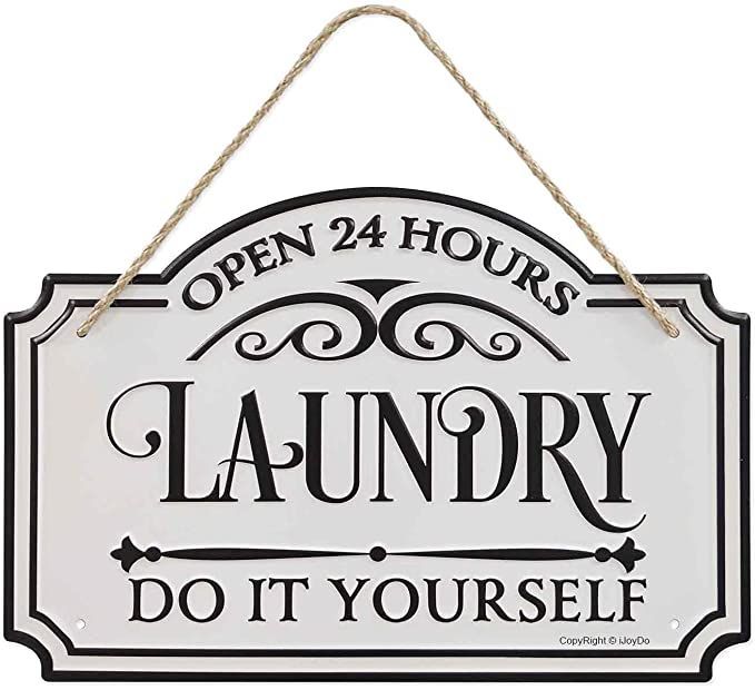 a sign hanging from the side of a wall that says, open 24 hours laundry do it yourself